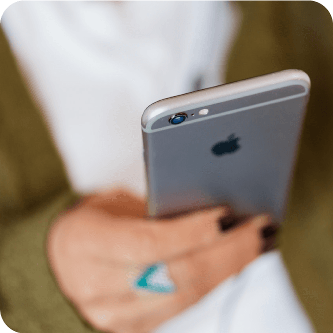 Woman sends a text alert from her smartphone