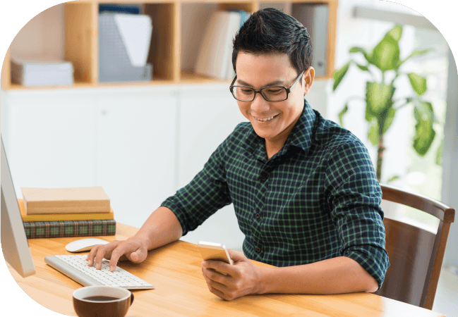 Businessman uses SMS opt in on his mobile device while working